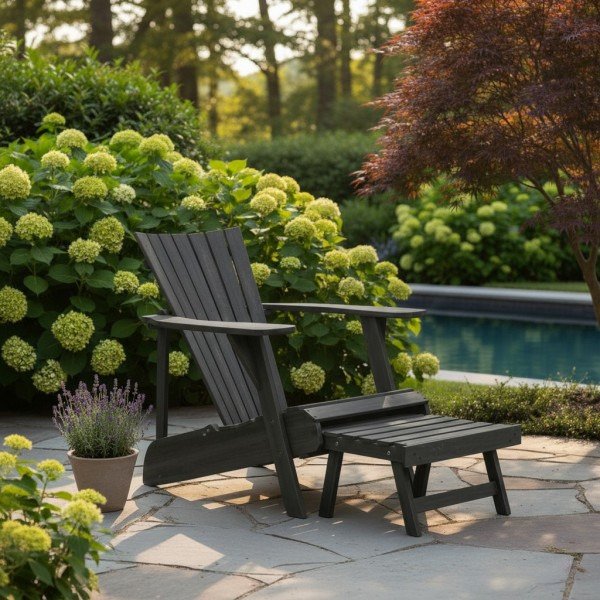 Stylish black Plastic Adirondack Chair with footrest for outdoor garden and poolside relaxation