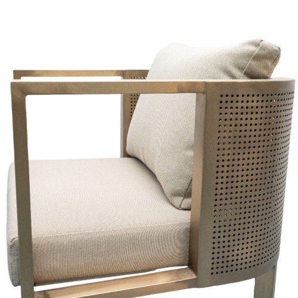 Side view of Stainless Steel Dining Set chair with beige cushion and perforated steel frame