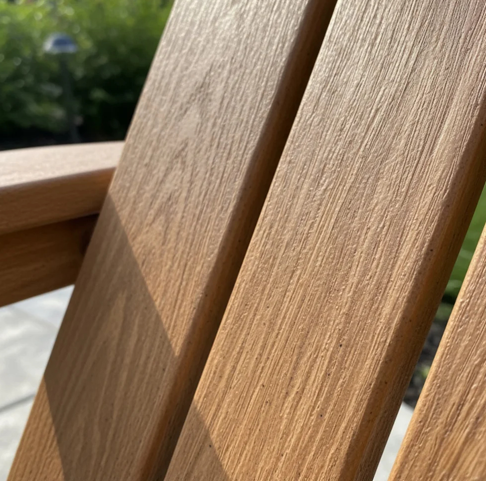 Close-up of wood-plastic composite Adirondack chair material with textured finish