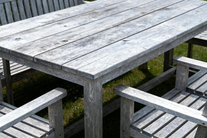 teak outdoor furniture aged silver grey in garden setting