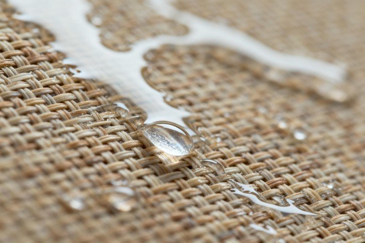 water droplets sliding off woven surface