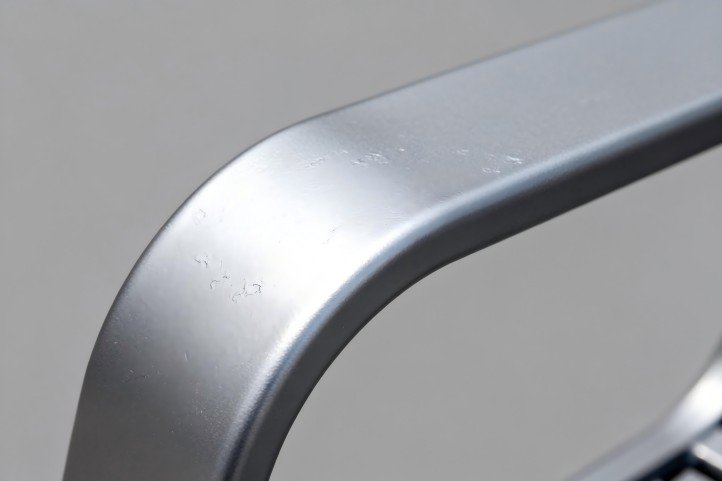 Close-up of AAMA 2604-grade powder coat on a cast aluminum armrest