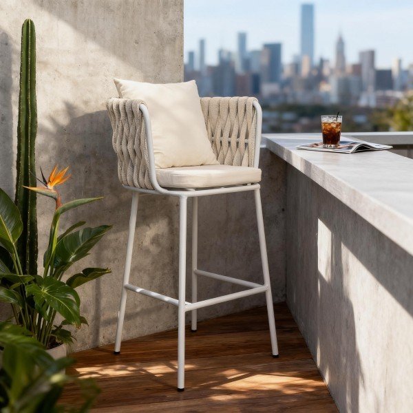 White woven-rope patio bar stool styled on a balcony beside a concrete ledge, wood decking and plants, showing scale and modern look.