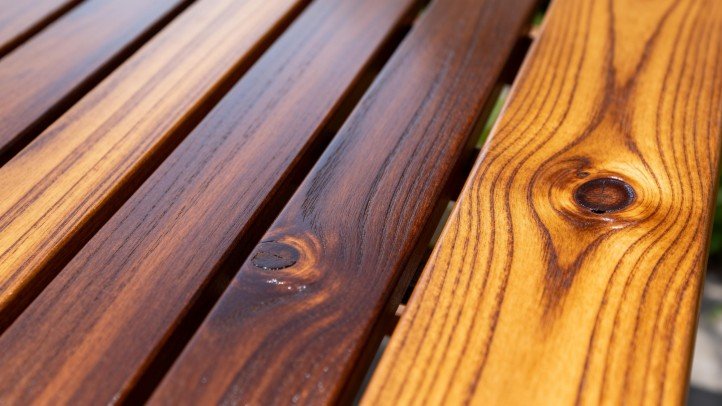 teak wood grain close up showing knots and oil texture