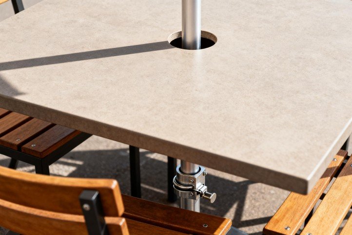 through-table umbrella pole with under-table receiver for extra stability