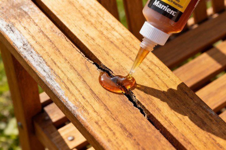 Filling a V-groove crack on a teak outdoor chair with marine epoxy